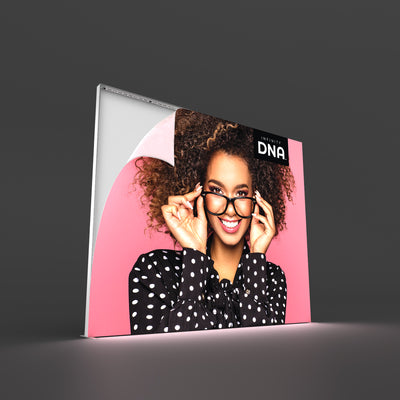 Large illuminated fabric display with smiling woman graphic for trade show and exhibition backdrop