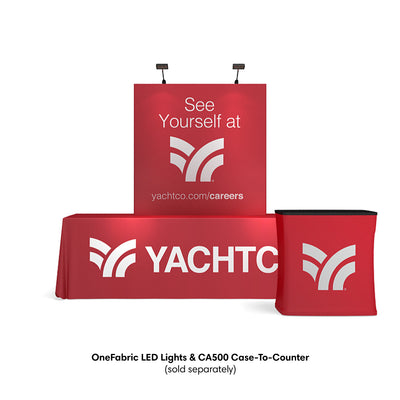 Trade show fabric display setup with table cover, backdrop, and case-to-counter for exhibitions