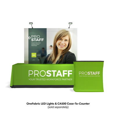 Trade show display featuring ProStaff branded tabletop exhibit with fabric counter and lighted backdrop