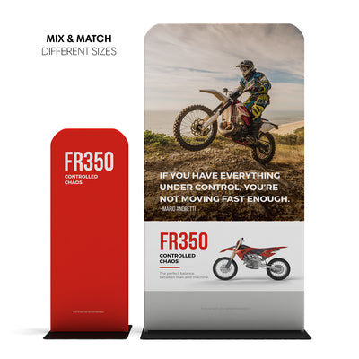 Trade show banner stands featuring motocross motorcycle graphics and promotional text for FR350 controlled chaos