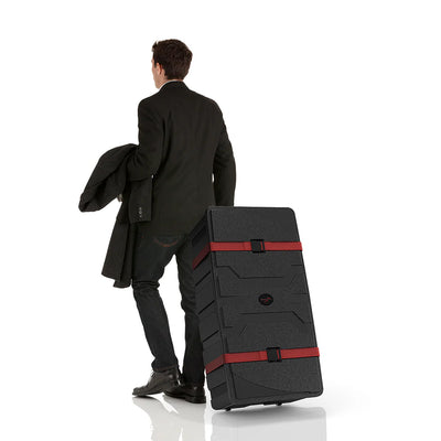 Man pulling heavy-duty transport case with red straps, ideal for trade shows and exhibitions