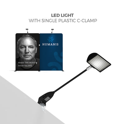 LED light with plastic C-clamp attached to trade show display panels for exhibitions and special events