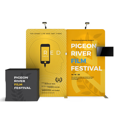 Trade show display booth with branded fabric backdrops and counters for Pigeon River Film Festival
