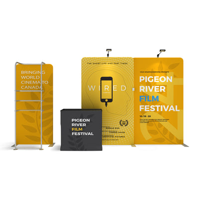 Trade show exhibit setup with backdrop, literature rack, and table cover for Pigeon River Film Festival