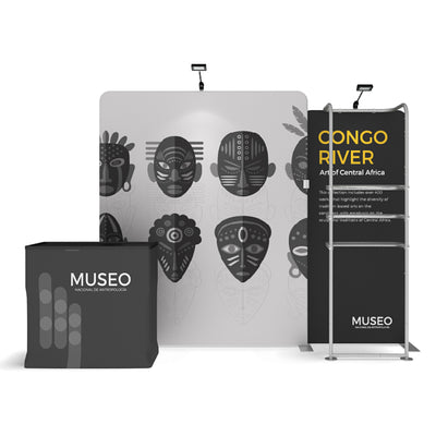 Trade show display with African mask graphics, branded counter, and informational banner for exhibitions