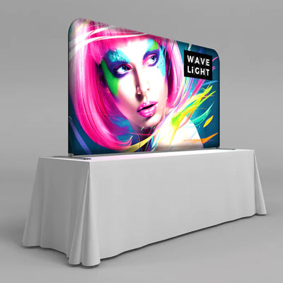 Trade show tabletop backlit display with vibrant graphic and WaveLight branding for exhibitions