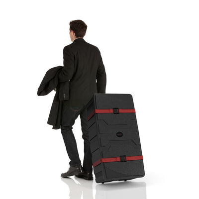 Man in business attire pulling a large durable trade show case with wheels for event equipment