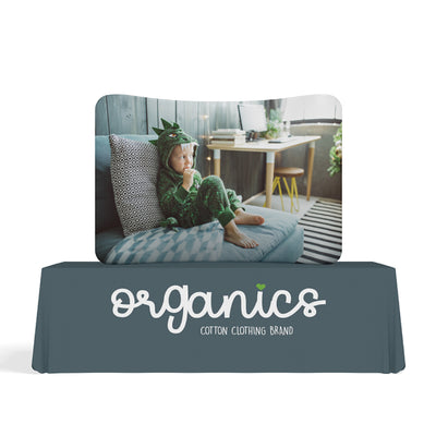 Curved tabletop display with child clothing brand image, ideal for trade show booths and exhibitions