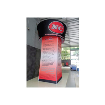 Tall trade show tower with circular hanging sign and promotional graphics for carpet binding and supplies