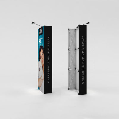 Tall fabric pop-up displays for trade shows and exhibitions with overhead spotlights