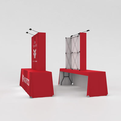 Pop-up trade show display setup with fabric table covers and vertical banner stand for exhibitions