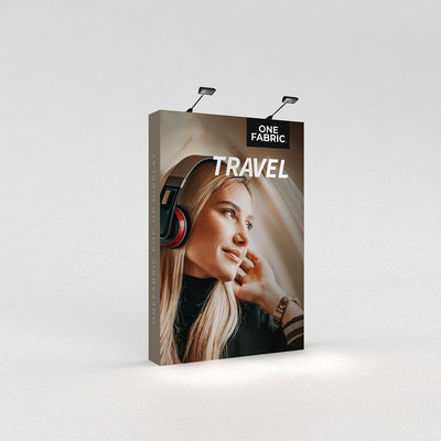Fabric pop-up trade show display featuring travel-themed portrait and branding