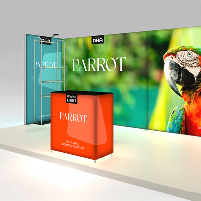 Trade show display system featuring large parrot graphic backdrop and inflatable lightbox counter for exhibitions
