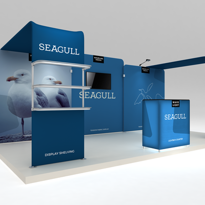 Trade show exhibit featuring tension fabric displays, display shelving, lightbox counter, and media screen