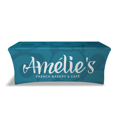 Trade show table covered with custom branded stretch table cover for exhibitions and events