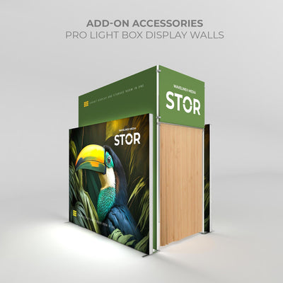 Trade show exhibit display with light box walls featuring tropical bird graphics and storage room